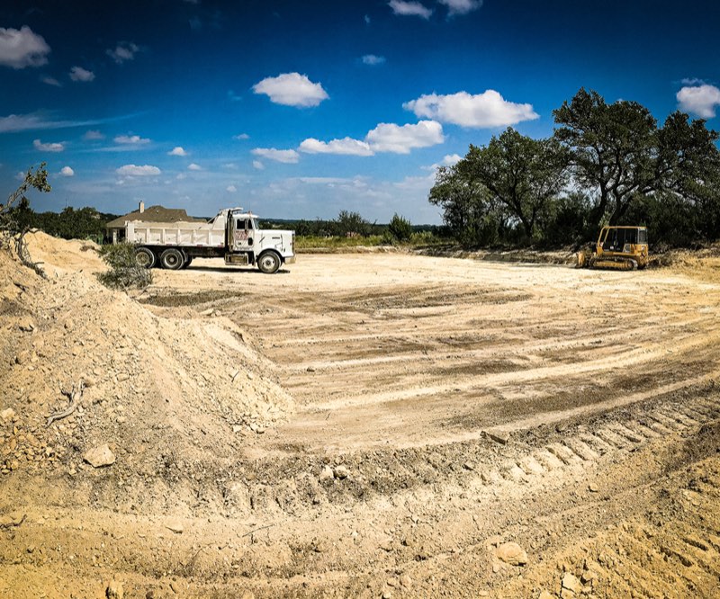 Building pad with dump truck and dozer